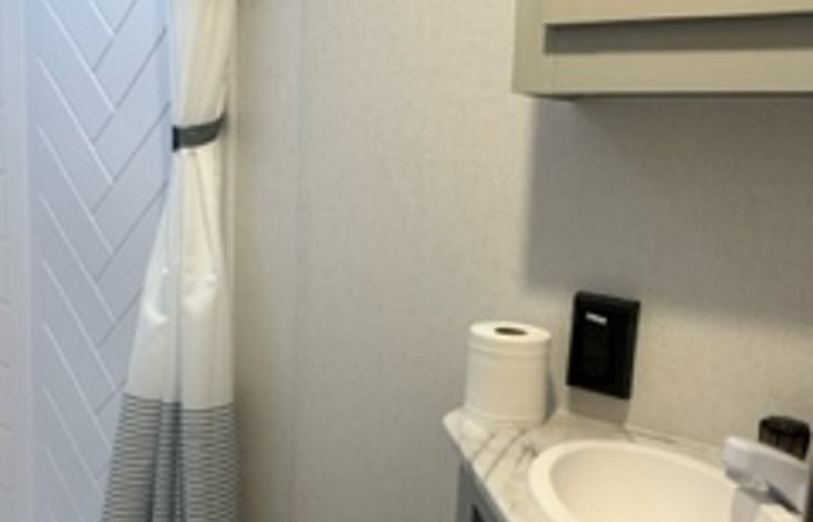 Mirror with cabinet and small storage underneath sink.