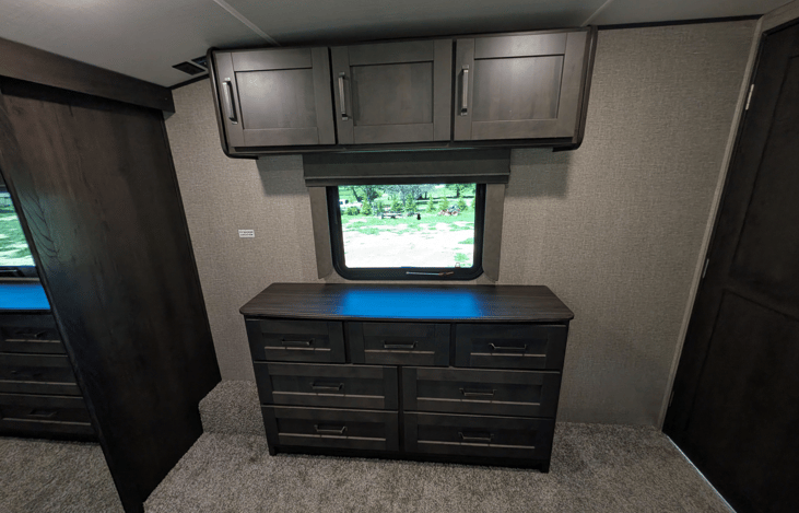 Private master suite with a queen bed, residential mattress, reading lights, deep dresser drawers, massive front wardrobe with hanging space, and washer/dryer prep. High-end restful comfort!