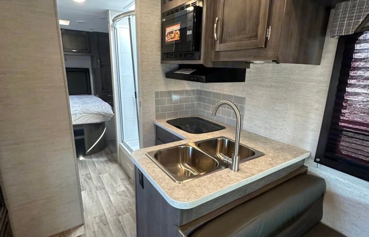 Convection microwave, two burner stove, and double basin sink allow you to feed the gang.