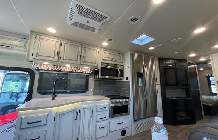 Kitchen area with the television with sound bar and fireplace