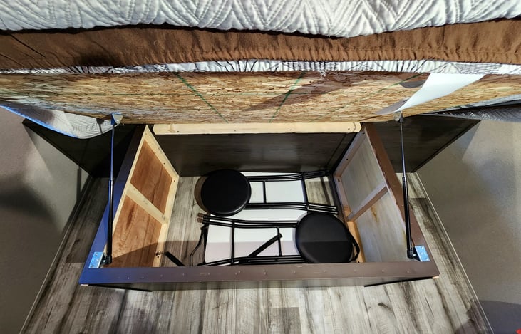 Storage under the master bed has a fold out table and stools for the peninsula and ample storage.