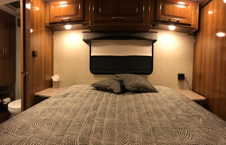 Queen sized bed with night tables with USB charging ports.