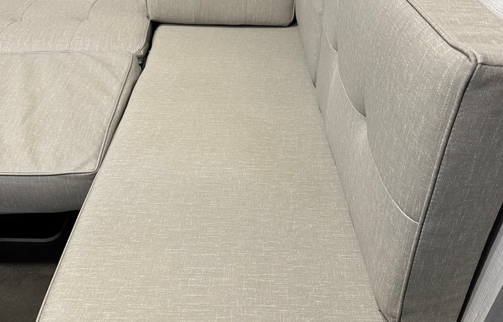 Chaise lounge in living room. Great to stretch out on and put your legs up.
