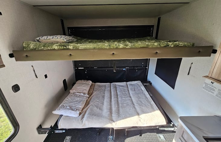 Layout with the top bed pulled down and couches made into a bed.