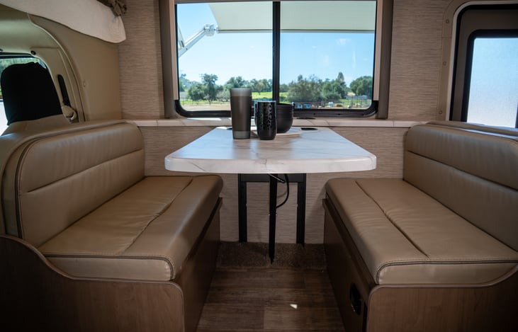 4 seater dinette features 4 seatbelts, one carseat anchor, 4 built-in cup holders, a wireless phone charger, and easily converts to a full sized bed!