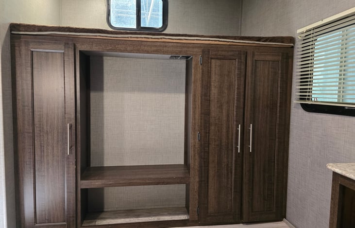 Upper bunk in bunkroom with storage underneath