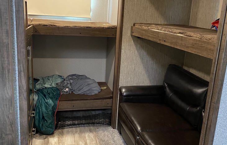 Kids Bunkhouse with 4 bunks and the couch opens to a cozy bed. Bunkhouse comes with its own bathroom and plenty of storage.