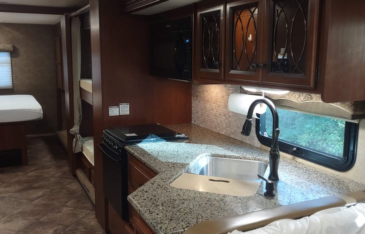 looking from dinette, thru kitchen & bunk/bath hallway to rear bedroom