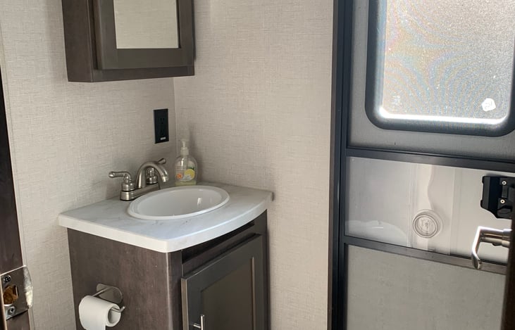 Half bath in the bunkhouse. Has a door to the outside.