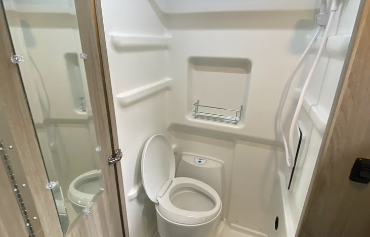 Full wet bath with grey water cassette toilet (empties on the outside of the van).  Shower also can be warmed to serve as a drying room for wet clothes
