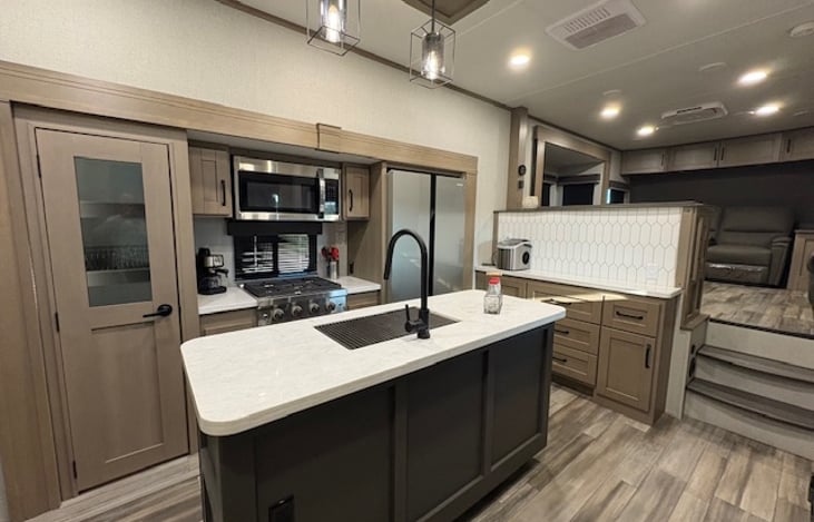 Spacious kitchen with residential sized refrigerator, microwave and stove.  Large pantry for storing all your non perishables.