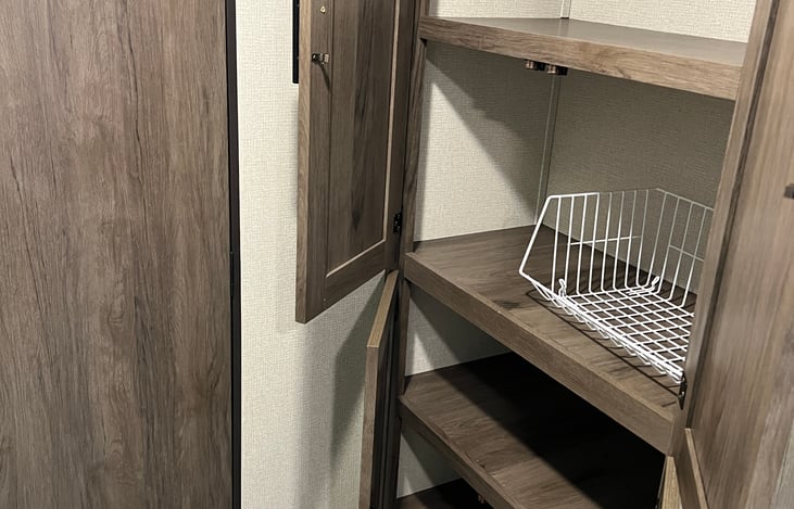 Pantry has tons of storage for food, towels or clothes for those sleeping on the loveseat.