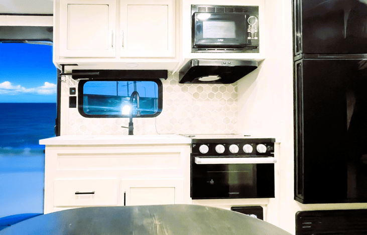 Fully equipped kitchen in your Jayco Jay Flight — perfect for affordable RV Rentals with all the essentials for cooking on the road. Jam Caravan comfort meets modern convenience.