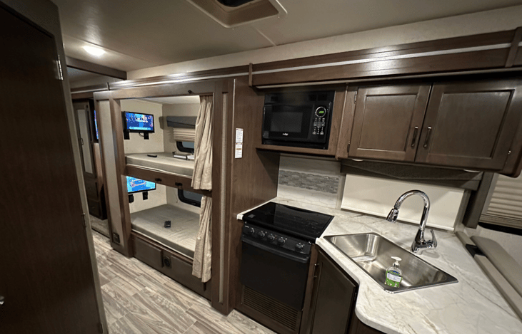 Kitchen has microwave and oven/range.