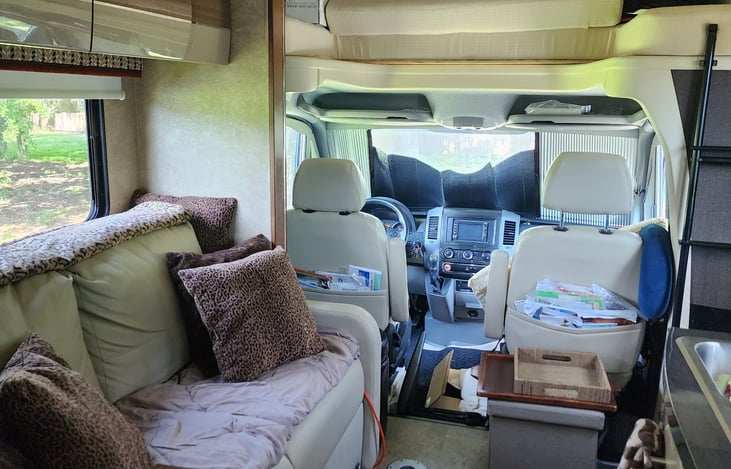 Leather loveseat with small desk/table. Cubes for storage and footrests while watching TV.