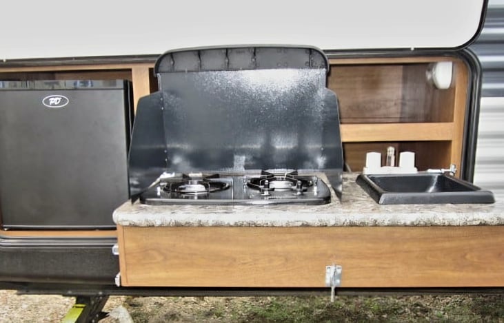 Outdoor kitchen,with 2 burner stove,mini fridge, and sink!!  Also storage for outdoor games, bug spray etc.