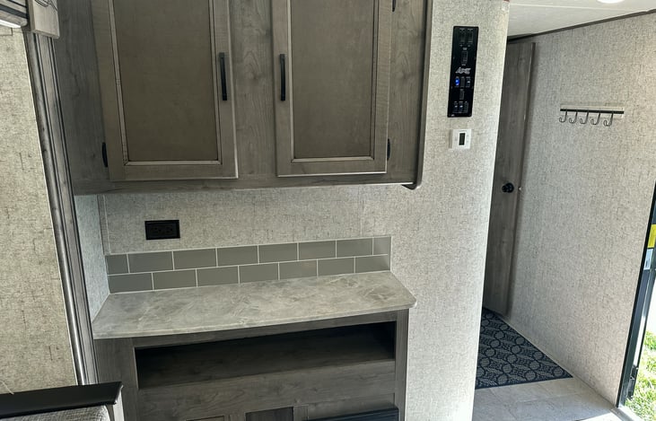 Side counterspace for coffee pot and other items.