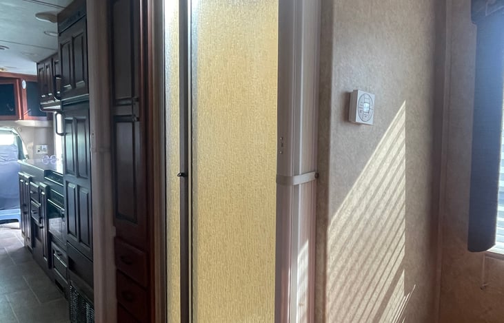 view from bedroom towards shower (across from toilet) towards kitchen