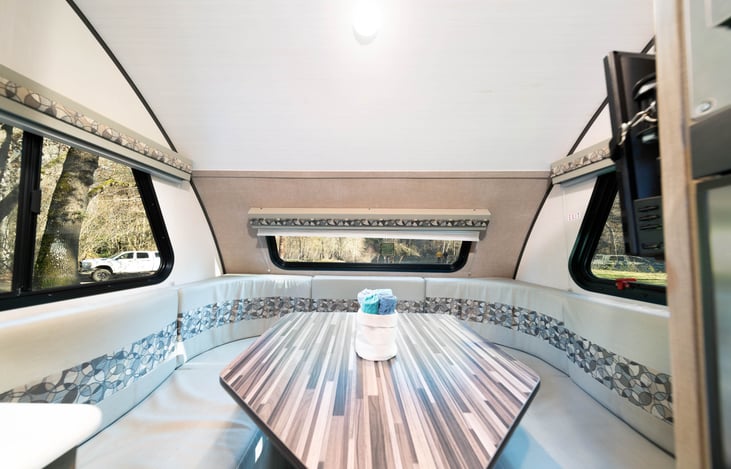 Dinning table drops down and converts to comfortable queen bed. You do need to bring your own bedding for this (sleeping bags and a couple pillows works great!)