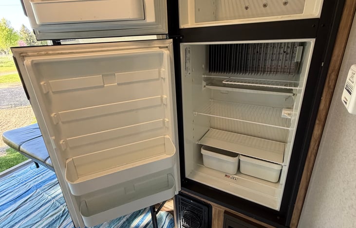 Spacious RV refrigerator with extra freezer space on top to keep your food, drinks and ice cream cold during your trip.