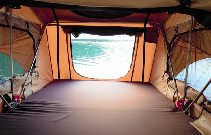 A serene look out of three windows-- we love setting camp by the water and seeing water all around. The foam mattress is comfy!
