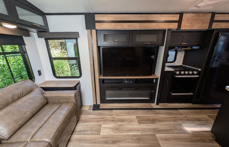 Big TV and faux fireplace, comfy couches and ample storage throughout.