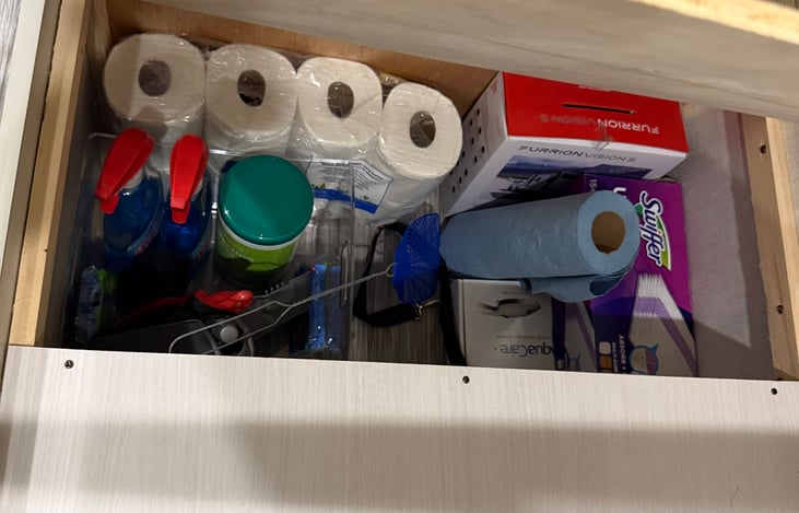 Cleaning supplies and more storage underneath dinette seats.