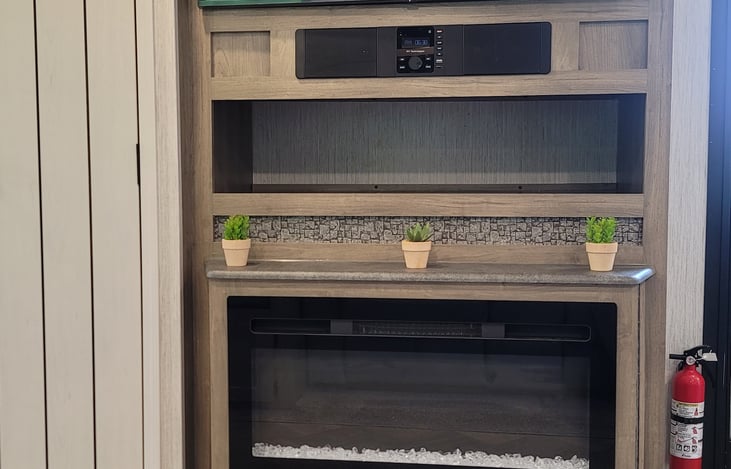 Enjoy movie night with the fireplace illuminating the living area.