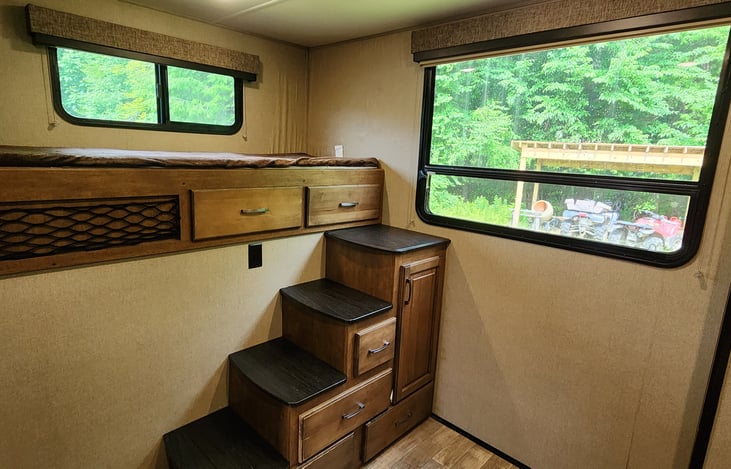 The rear bunk room includes two high single bunks and a sofa bed.