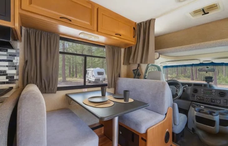 Enjoy meals with a view in this inviting RV dining area — the perfect spot to share food, laughs, and stories after a long festival day