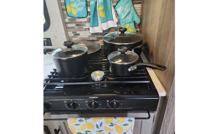 clean 4 burner stove with pots and pans