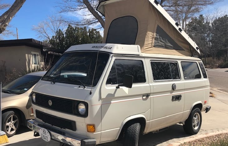 Front drivers-side view.  Front and side panels of pop-top fabric have screened windows for ventilation.