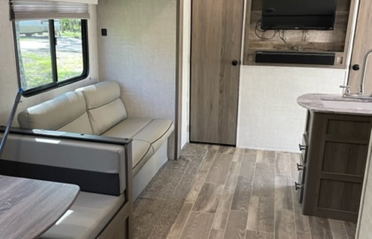 Pull out sofa in spacious living room and a Roku TV with surround sound.