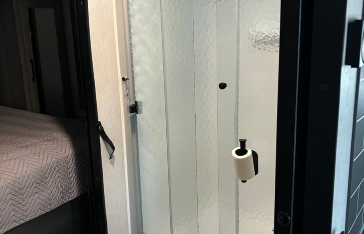 Large shower in walk through bathroom.