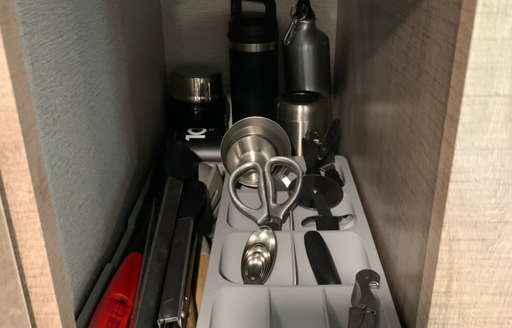 Fully stocked with kitchen utensils.