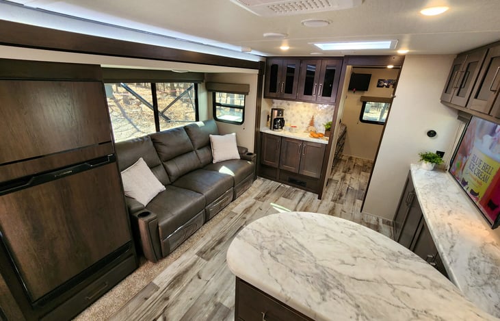 Large living room area with a coffee bar.