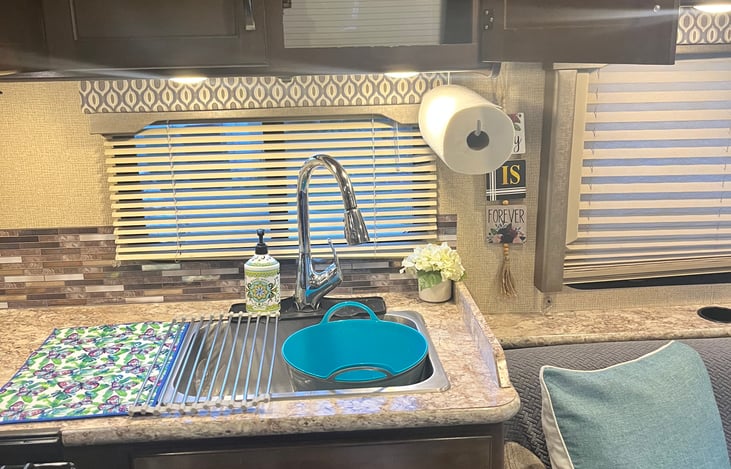 Kitchen area with overhead cabinets