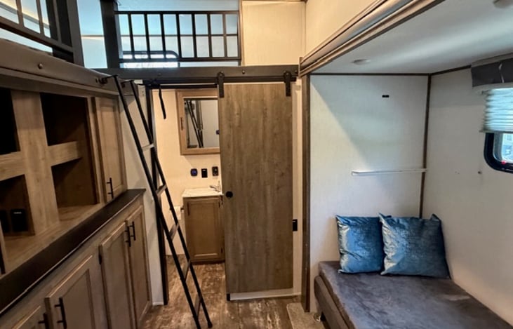 Two top bunks. Linens will be provided. Seating area can also be used for sleeping.