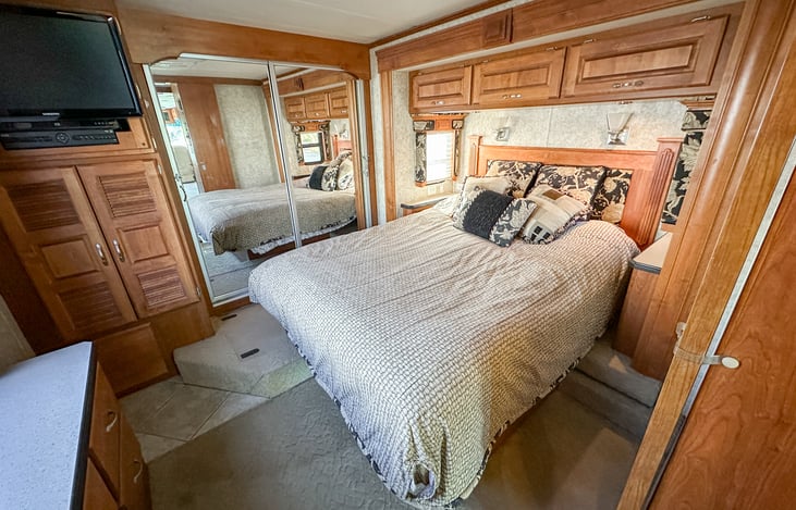 Master bedroom features a proper normal Queen size mattress, closet with dual sliding glass doors, made larger by huge slideout.