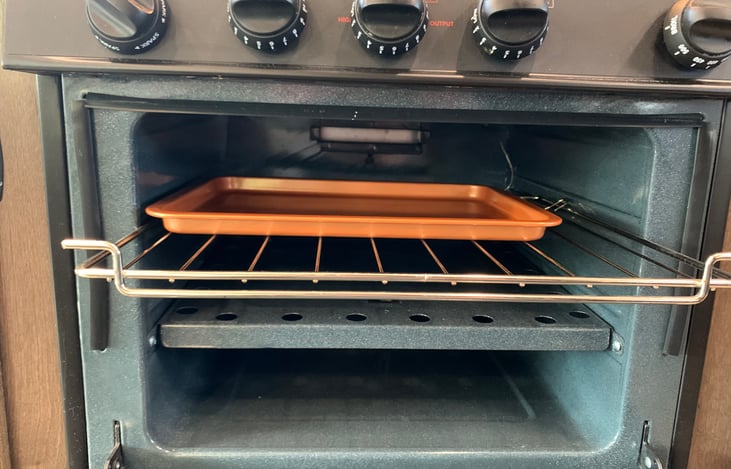Added bonus, a small propane-powered oven for baking cookies or a frozen pizza. We recommend disposable aluminum baking sheets for easy clean up.