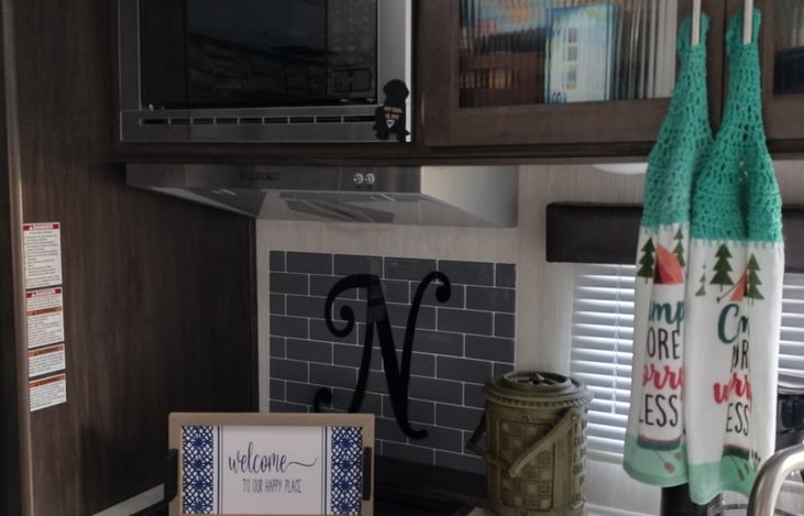 Stove, microwave and farm house sink. Overhead cabinets and a coffee maker....the most important. ☕