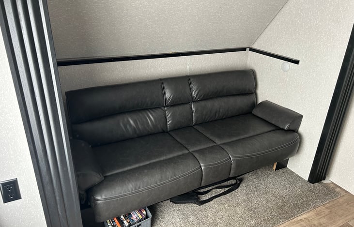 Upper bunk is able to be secured up for additional head room for the bottom couch/bed