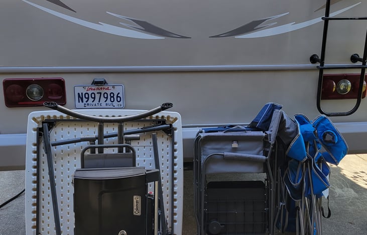 Colman propane grill, table, outdoor chairs