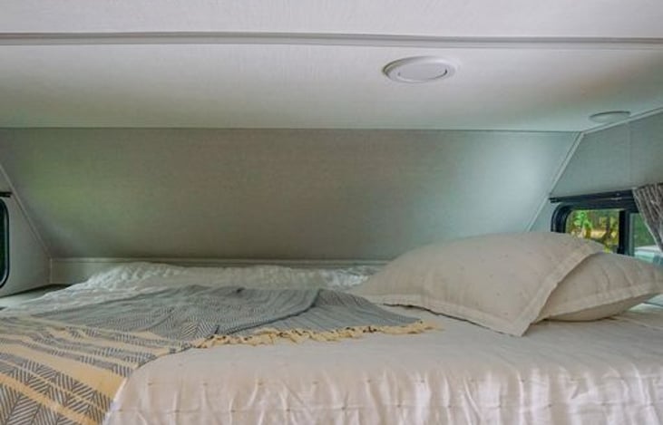 Bunk room has a little storage area and cupholders.