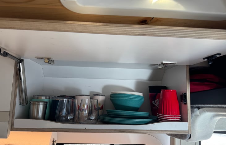 Cabinet above sink with dishes