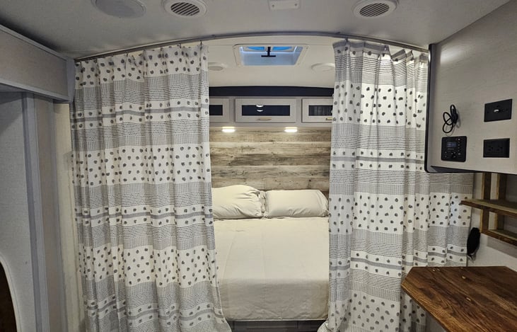 Cozy queen bed nook with overhead storage