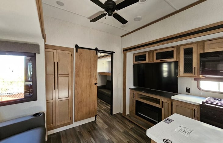 Kitchen, dining and living room. Includes smart tv, sofa/recliner, island sink, gas cooktop and oven, microwave, full-size refrigerator/freezer, pantry storage, dining table/chairs for 4 person