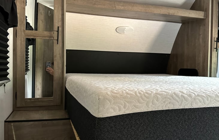 Queen Size extra Thick Mattress. Bedding and Pillows Provided for Primary Bedroom. Also has Closet on each side of Bed, and TV.