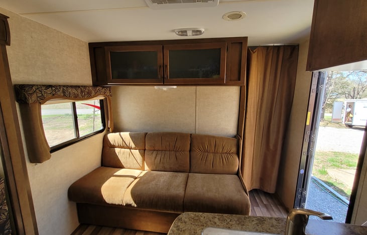 Living Area Couch: Storage Above & Below.  Privacy Curtain for Bedroom Area.