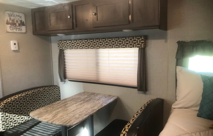 Dinette table (converts to twin bed) with overhead storage and storage under seat